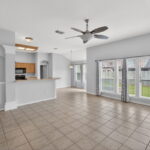 This family room is spacious looking towards the kitchen and breakfast nook.