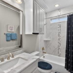 Bathroom for the 3rd & 4th guest bedrooms with tub and shower.