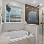 Jetted Tub & Walk-In Glass Shower With Tile Accent.