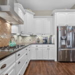 Kitchen features include a beautiful backsplash and walk-in pantry.