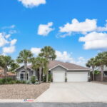 Professionally enhanced landscaping. Multiple mature Florida Sabal palm trees.