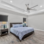 Large owner's suite - tray ceiling and oversized ceiling fan.