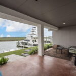 FIRST FLOOR, waterfront covered patio just off first floor bedrooms
