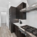 SECOND FLOOR - Kitchen with built-in oven/mircowave, coffee bar, gas stove top and door to the laundry area.