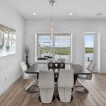 SECOND FLOOR - Dining area with door out to the covered decking overlooking the water.