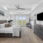 SECOND FLOOR - Massive Primary Bedroom with doors out to the private balcony with water views.