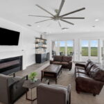 THIRD FLOOR - Living area or game room with fireplace, wet bar and doors out to the covered patio