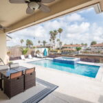 Covered patio overlooking the pool and water canal