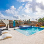 Pool, hot tub, and views of the water canal