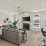 Entry opens to living area with fireplace looking out to the pool and water canal.