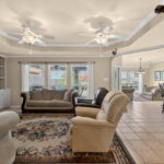 Open floor plan with views of the covered patio and pool.