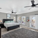 2nd floor primary suite with an access door to the 2nd floor covered patio & the spiral staircase to the crows nest landing. Awesome Views!