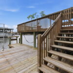 Lower deck with swim ladder, fish cleaning table, and boat slip.